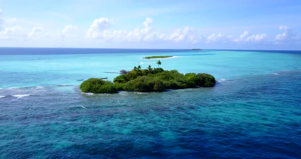 Daytime aerial island view of a sandy white paradise beach and blue sea background in best quality 4