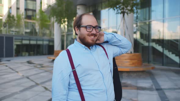 Attractive Happy Overweight Businessman Walking Outdoors in Street Carrying Jacket