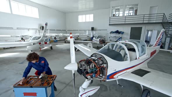 Female Maintenance Engineer Working with Aircraft Engine