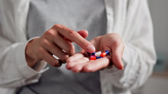 A Young Girl Is Looking For Painkillers In Pile Of Medicinal Preparations Painkillers For Depression