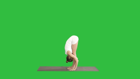 Beautiful model doing yoga exercise standing in Uttanasana