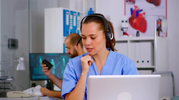 Specialist Doctor Nurse with Headphones Checking Appointment
