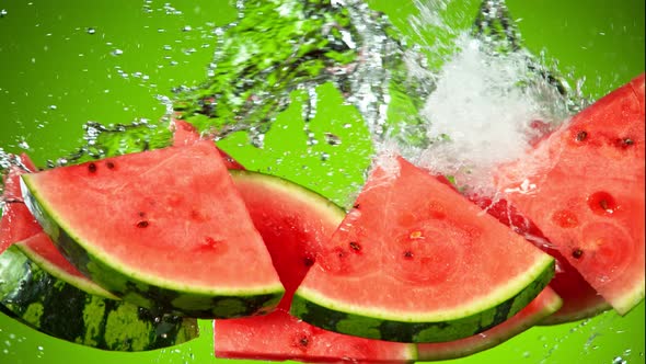 Super Slow Motion Shot of Flying Fresh Watermelon Slices and Water Side Splash at 1000Fps.