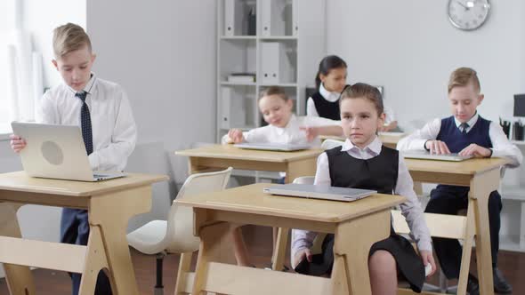 Schoolchildren Returning from Break and Opening Laptops