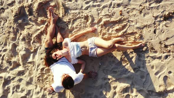 Young couple happy together on luxury lagoon beach wildlife by transparent lagoon and white sand bac
