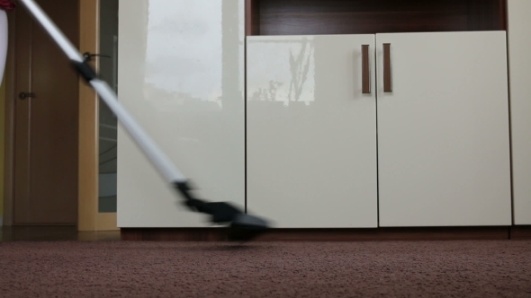 Mother With Her Baby Clean Apartment a Vacuum Cleaner