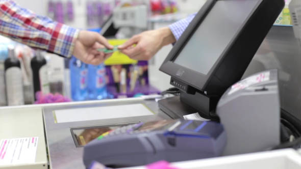 Man  is Shopping, Paying by Credit Card 