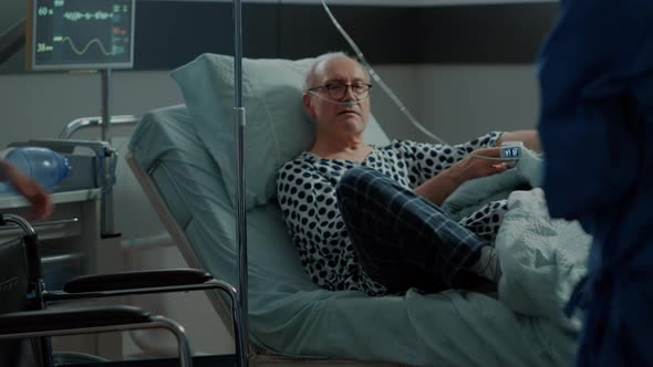 Old Patient From Hospital Ward Sitting in Wheelchair