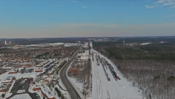 Freight Train By Railways Station Track in Winter Snow Covered