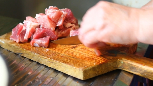 Woman Cut Pork Meat On a Cutting Board, 