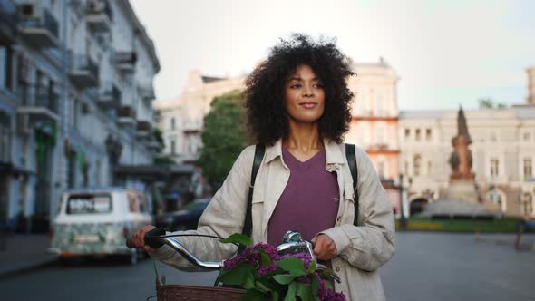 Ethnic Black Girl with Afro Hairstyle in Casual Clothes and Rucksack