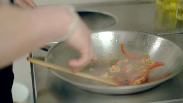 Cook Roasted Shrimps with Vegetables in a Frying Pan, Watered Them with Sauce.