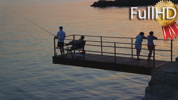 Sunset Over the Sea With Fishermans on the Pier