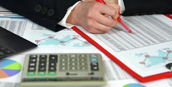 Businesswoman  Counting On Calculator