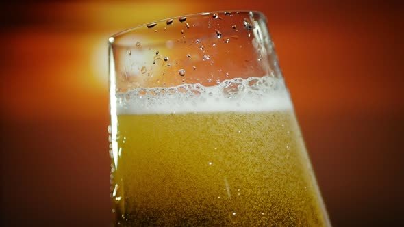 Beer Being Poured To Glass At Sunset