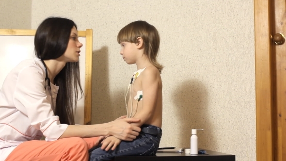Woman Cardiologist Conducts Reception And Examine The Boy