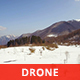 Aerial View of Snowy Mountains in a Sunny Day - VideoHive Item for Sale