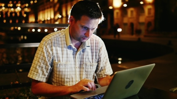 Working Late a Man With a Laptop alt