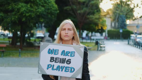 Pretty Girl Protesting Against Authorities That Playing Human Lives