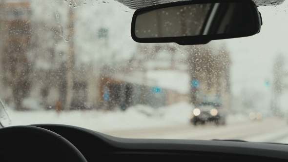 Cars Driving On a Snowy Road. The Reflection In The Rearview Mirror