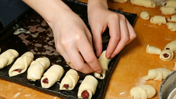 Baker Puts Croissants On The Baking Tray Pan alt