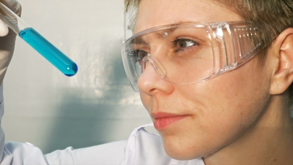 Doctor Scientist Looking At The Test Tubes In Lab