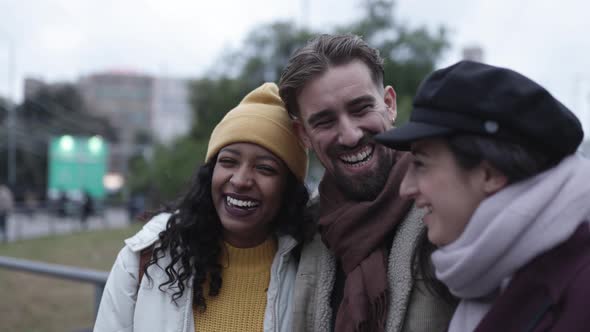 United Young Multiracial Friends Laughing and Having Fun in Winter Holidays
