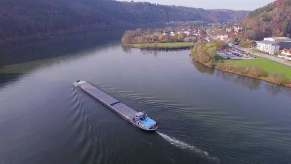 Cargo Pusher Boat on a River Transporting Cargo and Goods Along a River Bend