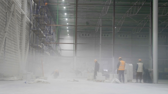 The Workers On The Scaffolding Inside a Large And Modern Warehouse