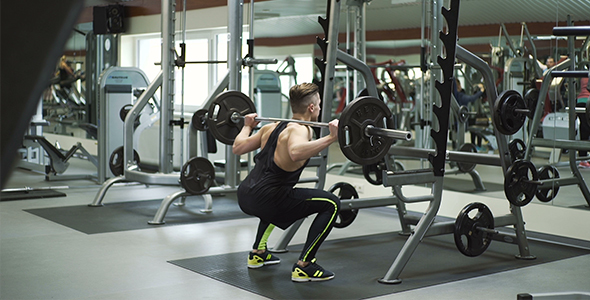 Athlete Performs Wide Stance Barbell Squats