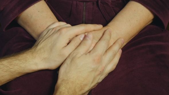 Male Hand Comforting An Elderly Pair Of Hands.