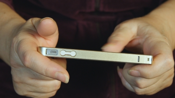 Hands Of The Old Woman And Smartphone.   alt