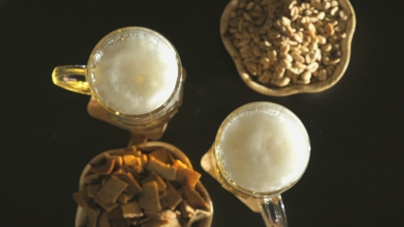 Two Hands With Beer Mugs Clink Over a Black Table alt