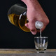Hand Serving Tequila on Black Background - VideoHive Item for Sale