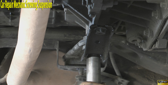 Car Repair Mechanic Screwing Suspension alt