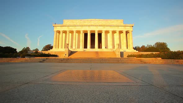 A tracking shot of the exterior of the Lincoln Memorial at dusk in Washington DC.
