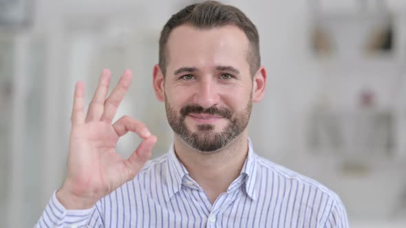 Portrait of Young Man Showing Okay Sign By Hand