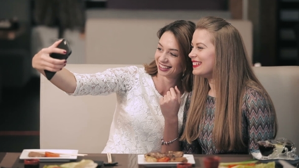 Two Pretty Girls Posing For a Selfie alt