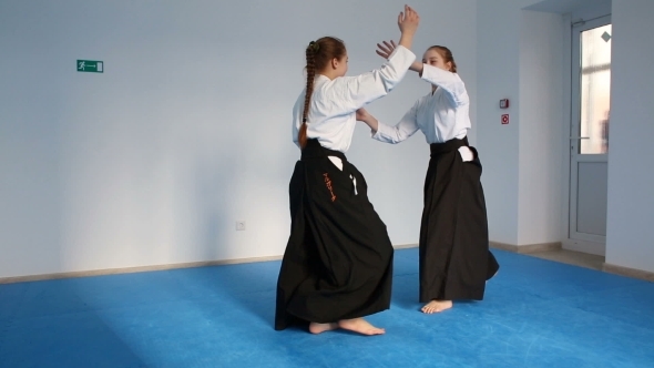 Two Girls In Black Hakama Practice Aikido
