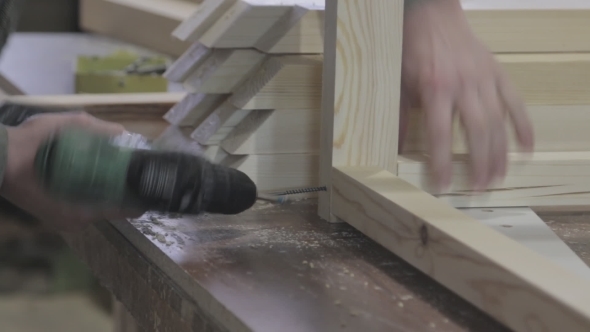 Worker Making Furniture Drill