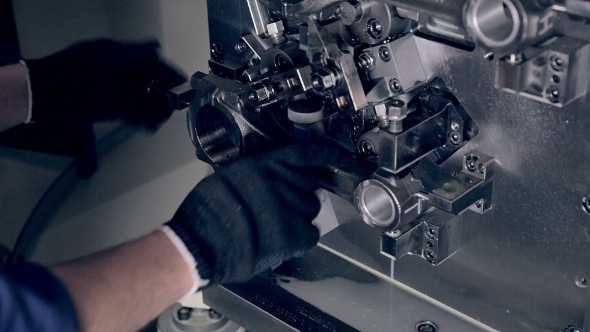 Worker Set Up Turning Milling Drilling CNC Machine. alt