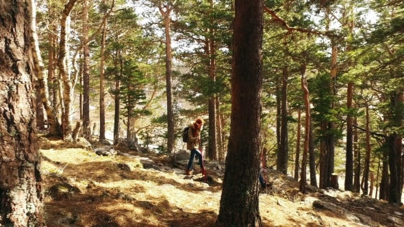 Couple Of Tourists Relaxing Outdoors With Backpacks