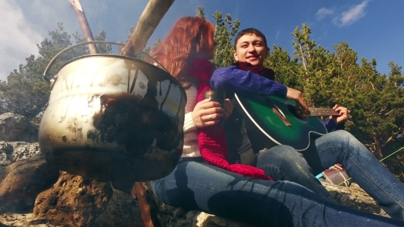 Couple Of Tourists Relaxing Outdoors With Backpacks