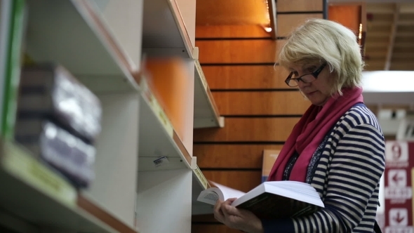 Blonde Woman Browsing Books In a Bookstore