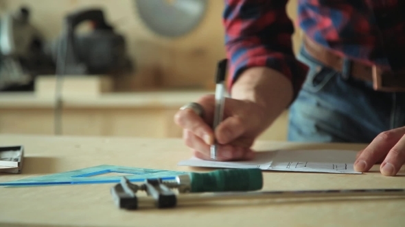 Male Hand Draws The Design On Paper