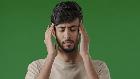 Close Up Male Portrait of Young Arabian Indian Unhealthy Sad Man Stressful Guy Massaging Temples