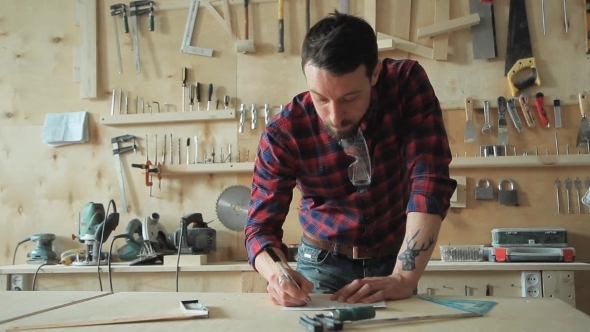 Master Thoughtfully Works In a Carpentry Workshop