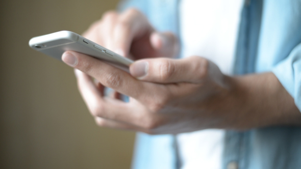 Casual Creative Man Browsing on Smartphone, Online alt