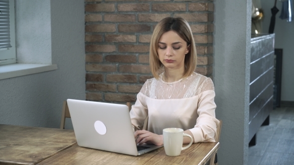 Young Woman Office Worker Typing On The Computer And Drinking Coffee