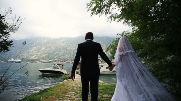 Wedding Couple Walking On The Romantic Bertn In Montenegro, Budva